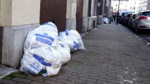 Little brown bag: White plastic rubbish bags in the street