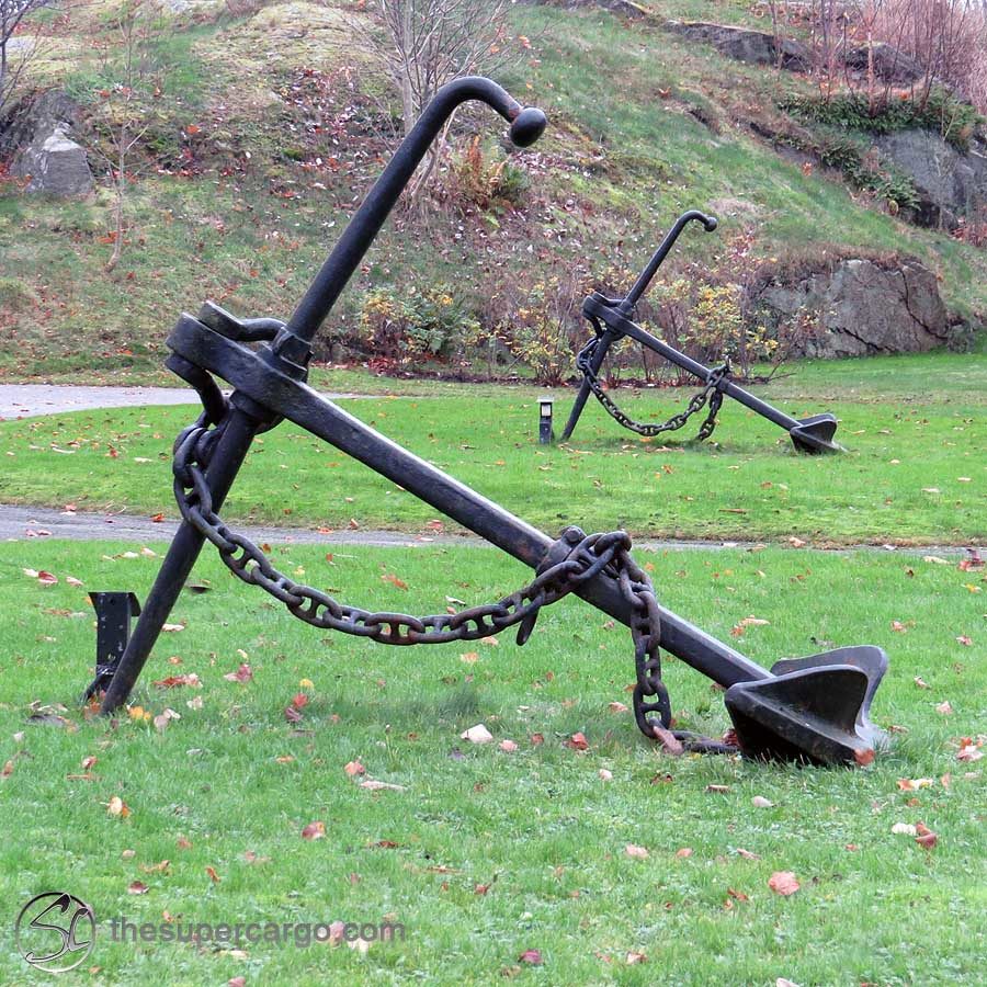 Anchors hold yoga poses on the grass in front of a former barracks, now a block of residential flats