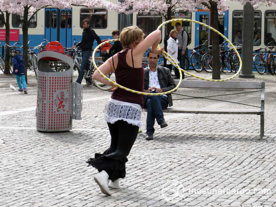 A street performer dancing with hoola hoops on Järntorget on the afternoon of Sunday 12th May 2013