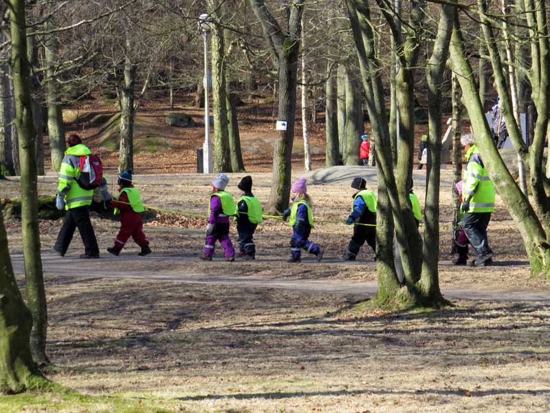 Kindergarten children and teachers in high vis jackets: Looking for signs of spring