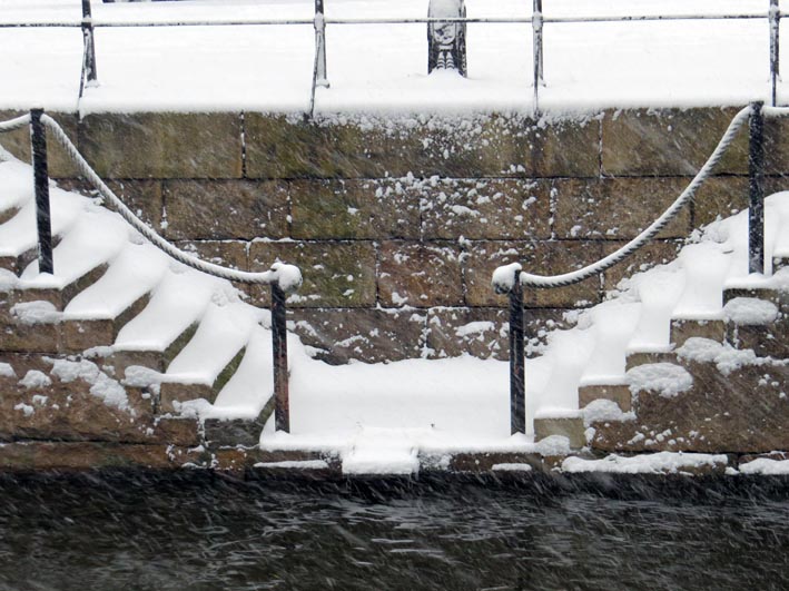 Water steps leading down to a Gothenburg canal, piled with snow although the water in the canal remains open. Photographed 8th December 2013.