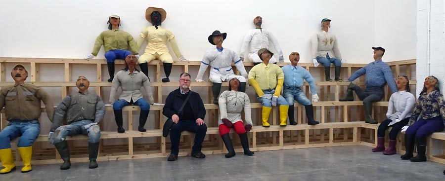 The author with some characters - sitting in an installation at a museum with a number of life-sized mannekins.