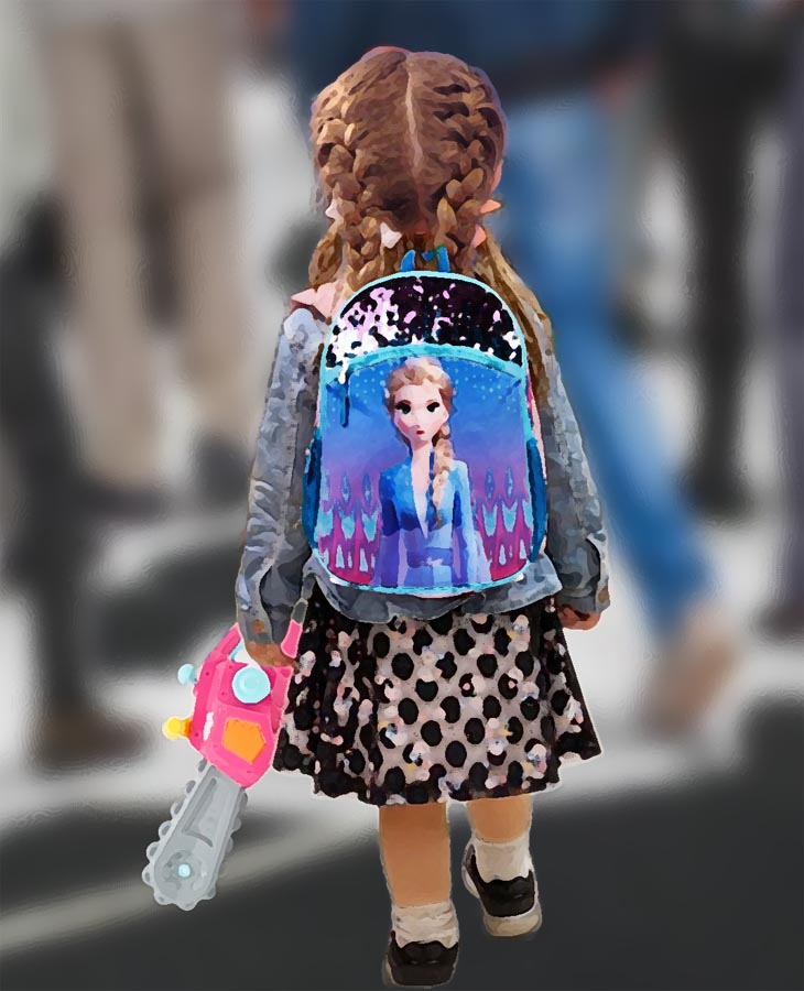 Little girl with pigtails, Frozen backpack anda toy chainsaw